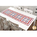 The completed table runner on a white table, demonstrating the finished project size, as well as showing the patchwork design in full.