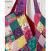 A super close up on the top of the bag and handle, demonstrating fabric prints and colors.