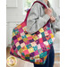 A model carries the Mondo bag on their shoulder, demonstrating colors of the fabric and scale of the bag.