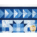A super close up image of the top of the quilt showing the flying geese details at the top of the quilt, as well as binding, and top stitching effects.