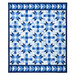 The completed Fly Over Quilt colored in blue and white fabrics from the Amalfi coast collection by White Owl Textiles, isolated on a white background.