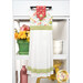 The completed Hanging Towel Kit colored in vermillion, green, and white fabrics from the In The Garden collection by Moda, hung on a drawer surrounded by coordinating décor. 
