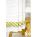 A close up shot of the bottom green and white striped fabric, a yellow stool can be seen in the background.