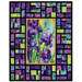 The completed Stained Glass Panel Quilt, colored in bright cerulean, purple, black, and green fabrics from the Infatuation collection by Northcott Fabrics, 