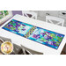 A shot of the runner staged on the white table, showing full color and print details on the panel pieces as well as the patchwork pinwheels.