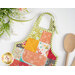 A close up on the adjustable strap on the apron hot pad. 