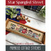 The front of the Star Spangled Street cross stitch pattern by Primrose Cottage Stitches showing the finished project.