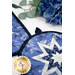 A close up on the round hot pad, demonstrating color and print details on the blue and white fabrics.