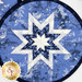A top down image of the folding star at the center of the hot pads, showing patchwork detail and symmetry of the design.