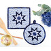 The completed Folded Hot Star Pads in dark blue, blue, and white fabrics from the Blue Belle collection by Maywood Studio, staged on a white table with coordinating decor.