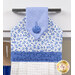 A close up shot of the top of the hanging towel. Classic florals can be seen in the white fabric.
