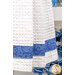 A close up shot of the bottom blue fabric, blue hydrangeas can be seen in the background.