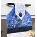 A close up on the top of the towel, demonstrating fabric colors and button closure detail.