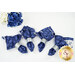 A top-down shot of the four napkins colored in the Blue Belle collection by Maywood Studio, featuring dark blue paisleys paired with simple white florals and silver rings.