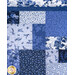 A super close up on the patchwork center of the quilt, demonstrating fabric, piecing, and top quilting details.