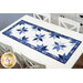 The completed Floating Stars table runner finished in dark blue, blue, and white fabrics from the Blue Belle collection by Maywood Studio, staged on a white table.
