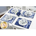 The four completed Fat Quarter Shuffle Mats, colored in dark blue, blue, and white fabrics from the Blue Belle collection by Maywood Studio, set on a white table with coordinating décor. 