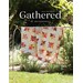 Front cover of the pattern, showing a beautiful patchwork star quilt draped over a fixture outdoors in a green garden on a sunny day.