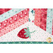 A super close up on one of the appliqué strawberries, showing fabric color and print details.