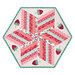 The completed 60 Degree Diamond Table Topper colored in bright pink, red, and green fabrics from the Berry & Sage collection by Riley Blake Designs, isolated on a white background.