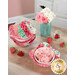 The four completed bowl cozies colored in red, pink, and green fabrics from the Berry & Sage collection by Riley Blake Designs, staged on a wooden table with coordinating décor and strawberry pincushions. 