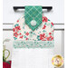 A close up on the top of the towel, showing details on the floral prints, tab, and fabric button.