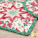 A stylized close up on the two hot pads, slightly overlapping, staged on a rustic wood table.