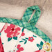 A super close up on the fabric loop of the round hot pad, demonstrating fabric print and color details.