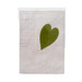 Olive green wool felt heart on a textured ash background.