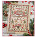 The finished cross-stitch sampler featuring a house, floral motifs, poinsettias, reindeer, and christmas trees surrounded by coordinating holiday décor.  