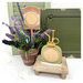 The fully assembled and painted Water Mister and plant Stick Cross Stitch Display, staged on a marble countertop with coordinating décor. The frames remain empty.  