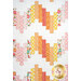 A head-on close up on the quilt, showing the flow of the dynamic patchwork as well as fabric colors.