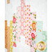 A close up on the patchwork of the quilt, demonstrating fabric colors and details on the summery prints.