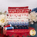 A stack of the fabrics included in the Blossom Jubilee Fat Quarter Bundle, with flowers and jars and a stand and thread.