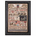 The completed cross stitch framed and isolated on a white background. 