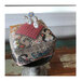 A side view image of the completed project featuring cats, a wool houndstooth square, and embellished pins sticking out.