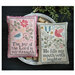 The completed cross stitch finished as a pillow sitting in a wooden bowl surrounded by coordinating décor.