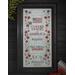 The completed project featuring the stitched Pledge of Allegiance, surrounded by red flowers and an American flag.
