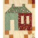 A head-on super close up on one of the patchwork houses, showing print and color details on the fabrics along with top quilting effects.