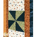 A close up on a pinwheel block, capturing fabric, patchwork, and top quilting details.