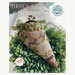 There's A Hare In My Garden cross stitch pattern showing the completed project staged in a bowl of greenery.