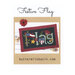 The front of the Festive Flag pattern, featuring the completed wool mat design on a patriotic background surrounded by coordinating décor.