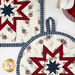 A close up shot of both the round and square hot pads, demonstrating stitching and binding details.