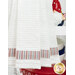 A close up shot of the bottom red, white, and blue striped fabric, a patriotic gnome can be seen in the background.