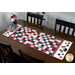 The completed American Glory Table Runner finished in patriotic fabric from the American Gatherings III collection by Moda, set on a wooden table and decorated with patriotic décor. 