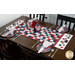 The completed American Glory Table Runner finished in patriotic fabric from the American Gatherings III collection by Moda, on a wooden tabel with four table settings. 