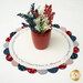 The completed table topper displayed on a white table with coordinating decor. 