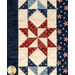 A close up on a patchwork pinwheel star, demonstrating fabric color, print, and top quilting details.