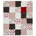 The completed Santa Suit Quilt Kit, a rag flannel quilt colored in red, white, and brown fabrics.