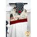 A close up on the top of the towel, demonstrating fabric colors and button closure detail.